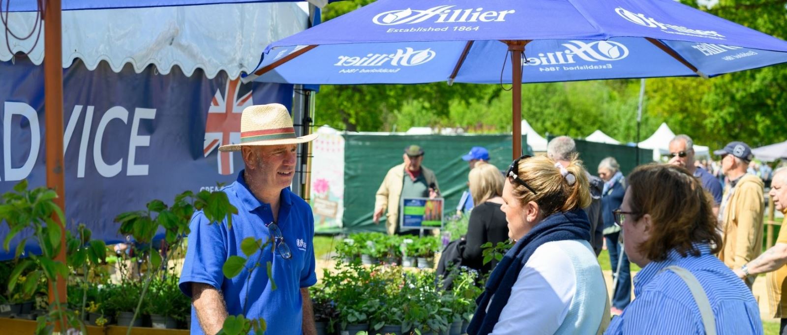 People talk to a stand holder at BBC Gardeners' World Spring Fair